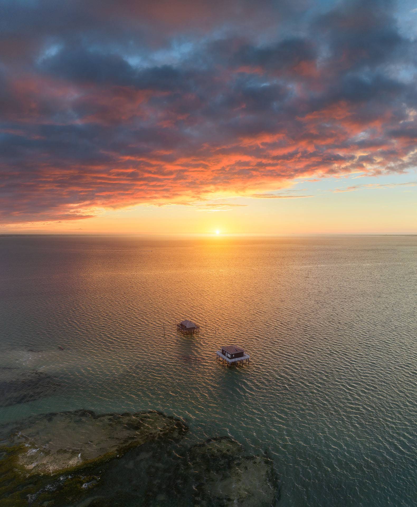 Photo du lever du soleil au dessus des cabanes tchanquées 